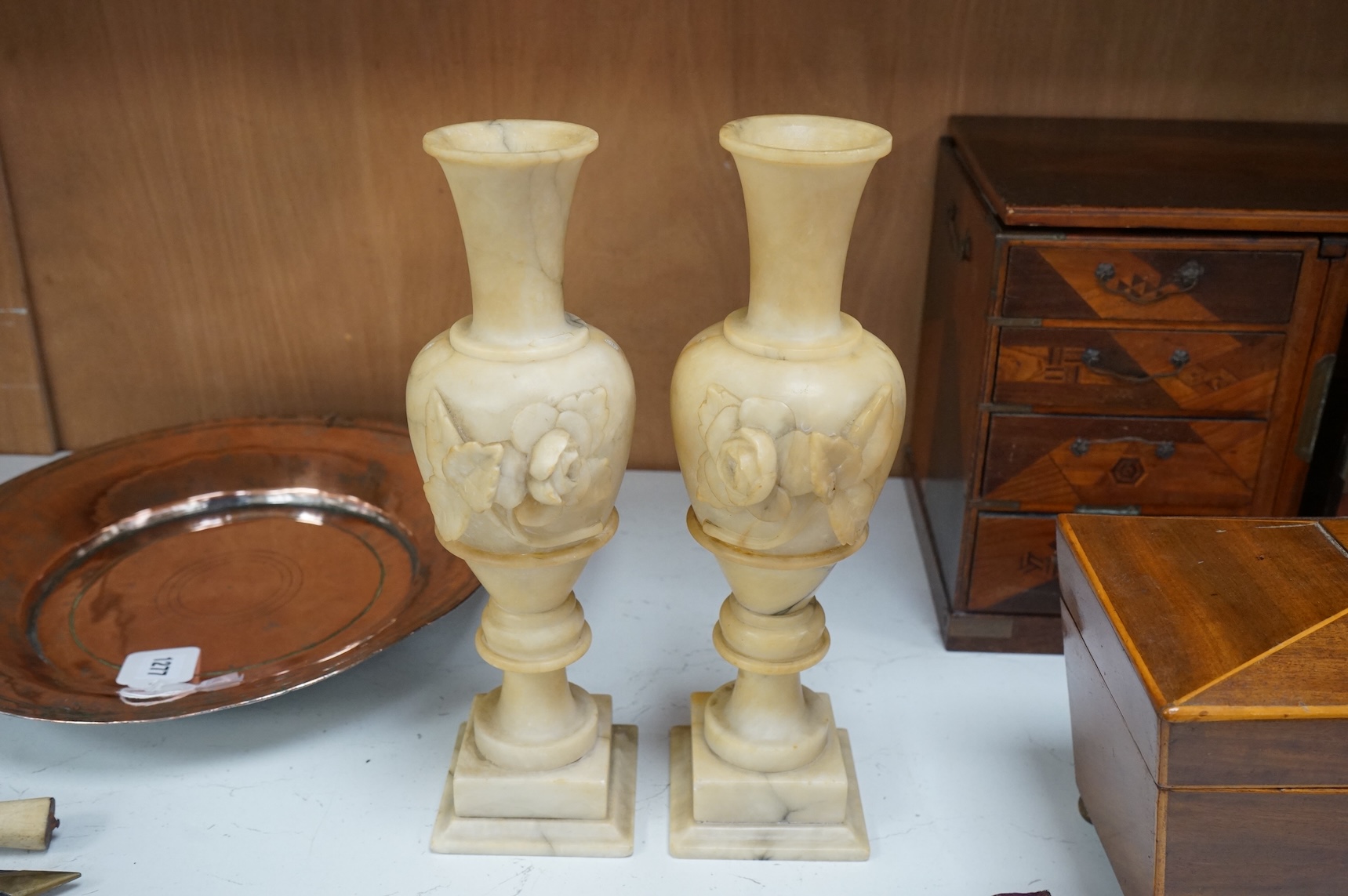 A pair of carved alabaster vases, 32cm high.